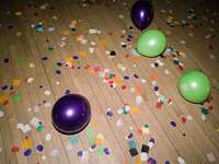 Balloons and confetti on the floor after a party ended