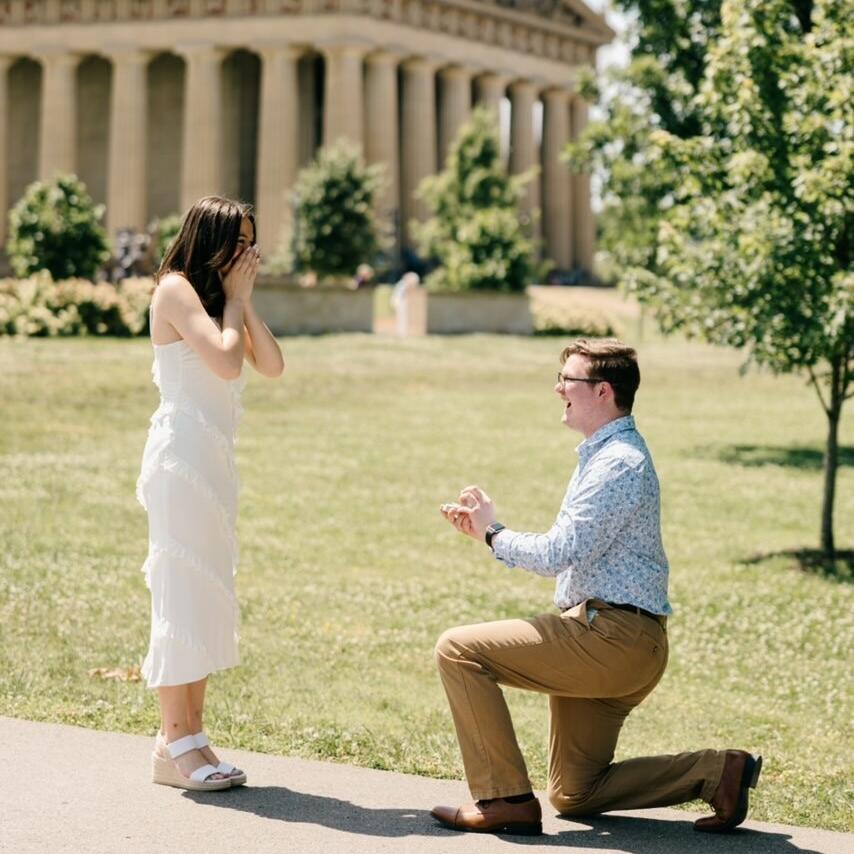 Then the day came. Dylan had Katie Ann's whole family lie to her and had her get her nails and dress nicely without her realizing she was getting engaged. Dylan planned for both of their family members who could come to hide and booked a photographer to capture the sweet moment. It was a lovely and private celebration, and the couple couldn't be happier with how everything turned out!