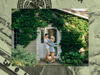 Couple standing in front of new home. 