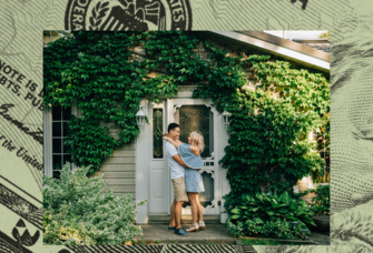 Couple standing in front of new home. 