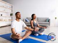 Couple meditating together at home
