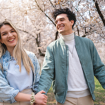 Couple walking and holding hands during the spring