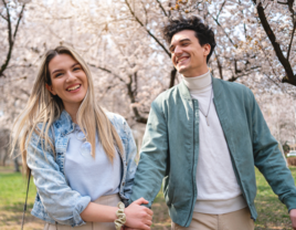 Couple walking and holding hands during the spring