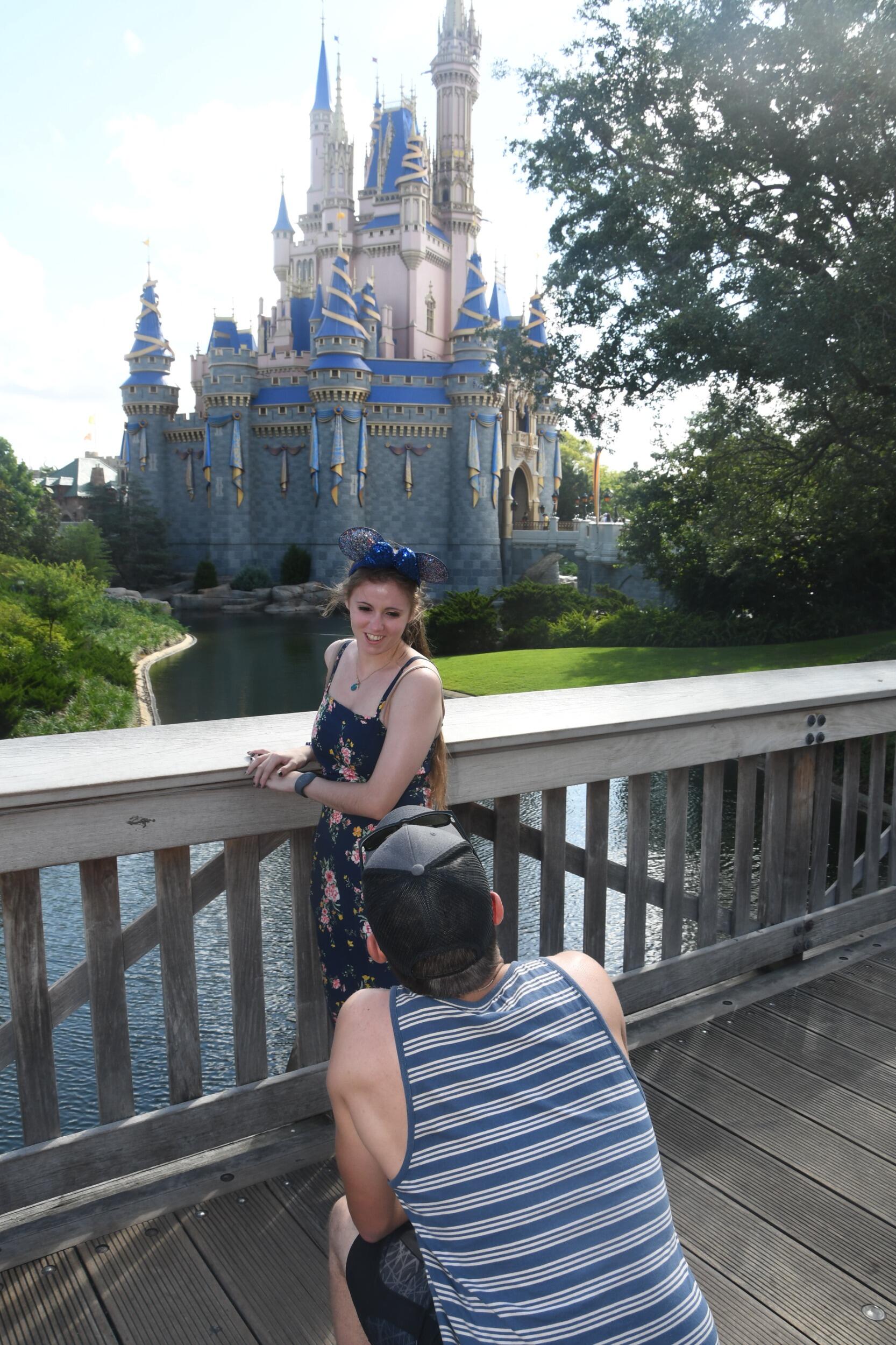 Kevin proposes to Tessa in front of the Magic Kingdom castle. 