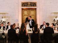 Bride and groom with wedding party at reception 