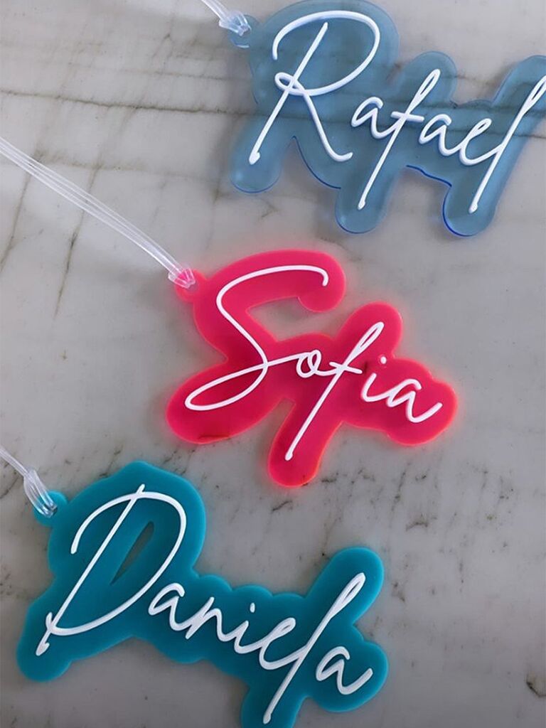 Names in acrylic neon sign design in blue, teal and pink