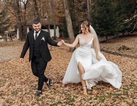 Happy couple walking outside surrounded by fallen autumn leaves