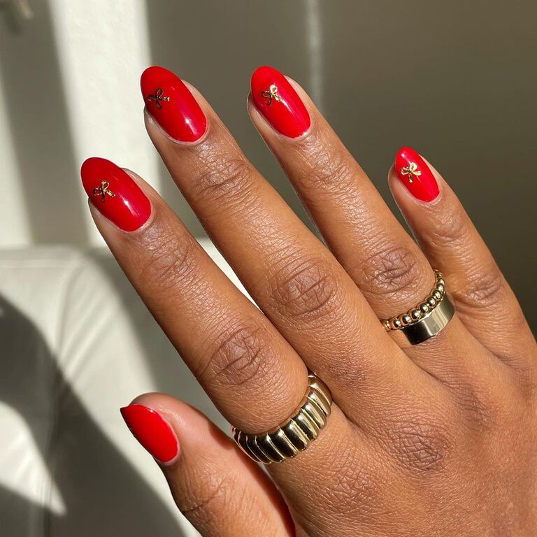 Red wedding nails with gold bow details