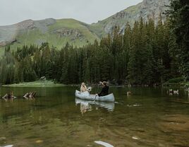 Bride and Groom on a Canoe Ride on a Lake at Their Telluride, Colorado, Venue