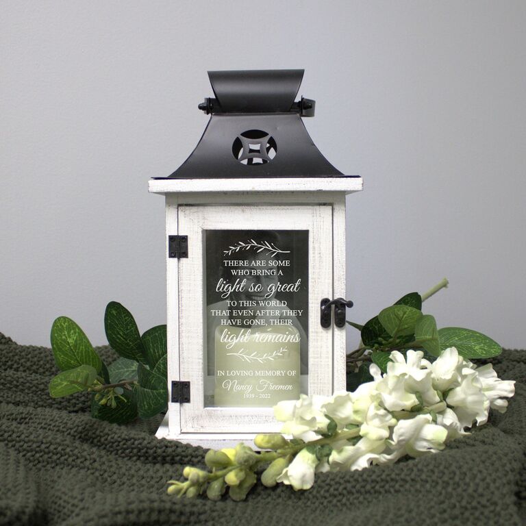 Black and white memorial lantern with writing on the glass