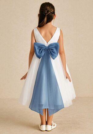 Kavi is our adorable flower girl dress cut from satin and tulle. She features a scoop neckline paired, the look is complete with an A-line skirt. This dress is not only perfect for a flower girl at a wedding but also versatile enough for other special occasions.