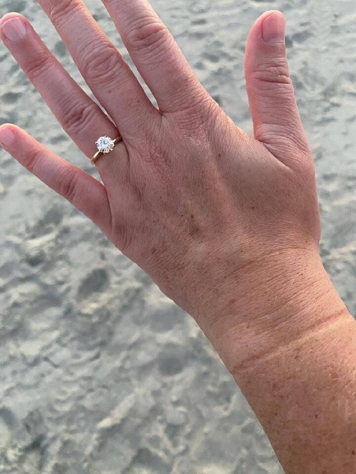 He got down on one knee on the same beach where he told Laura he first loved her and asked her to marry him. (Spoiler Alert- She said YES!)