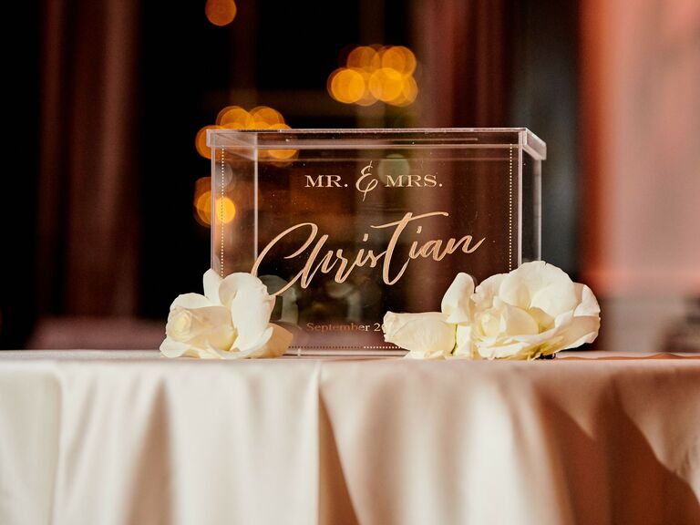 wedding gift table with acrylic wedding card box featuring mr & mrs christian written in gold calligraphy