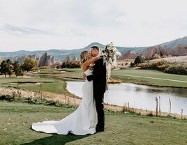 Husband and wife kissing on the golf course grounds