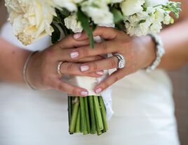 Bride with simple manicure holding bouquet