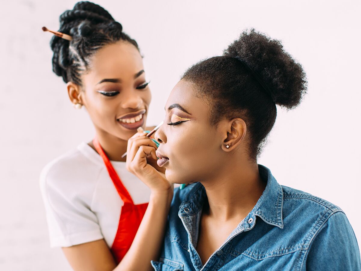makeup artist applying makeup to woman