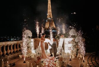 Proposal with a love sign and sparklers beside the Eiffel Tower