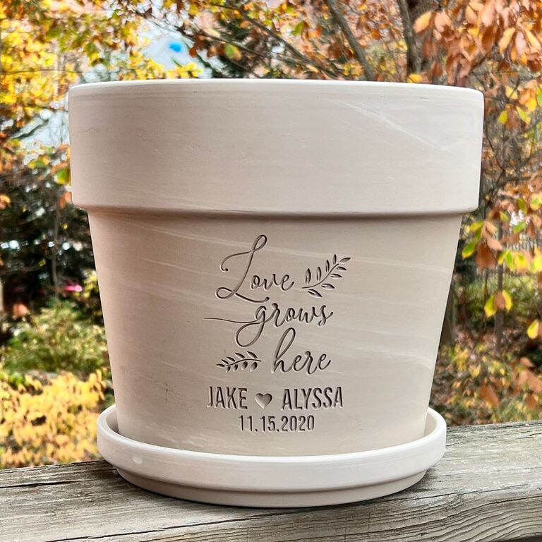 Personalized "love grows here" clay planter from Etsy