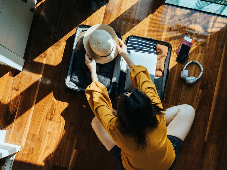 Woman packing suitcase for Bali