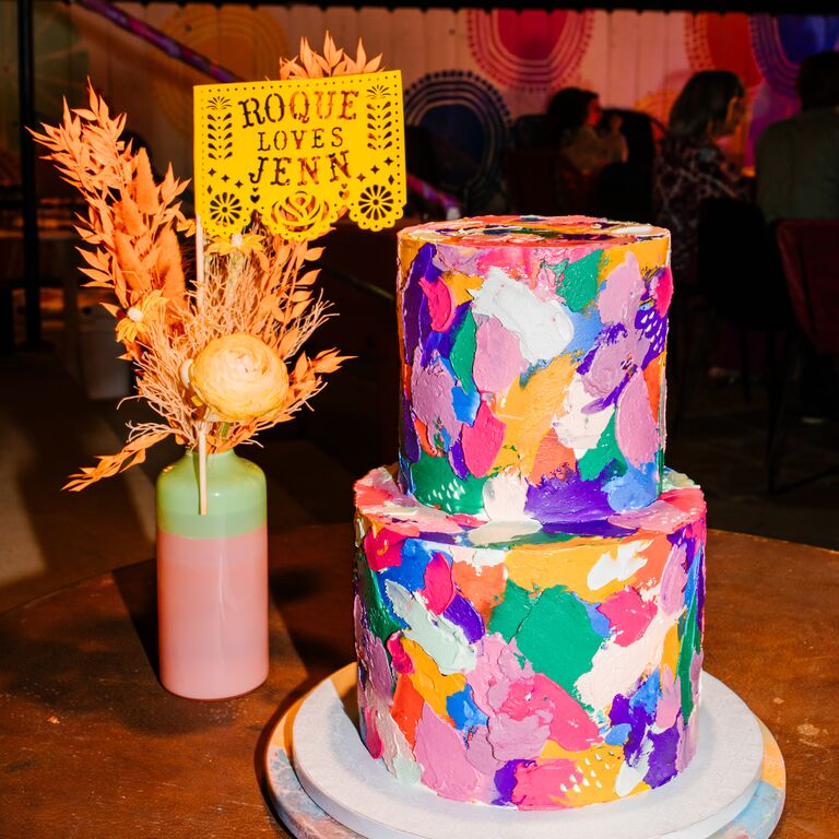 Prismatic colorful wedding cake with papel picado topper