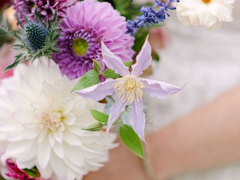 A wedding bouquet with purple clematis flowers