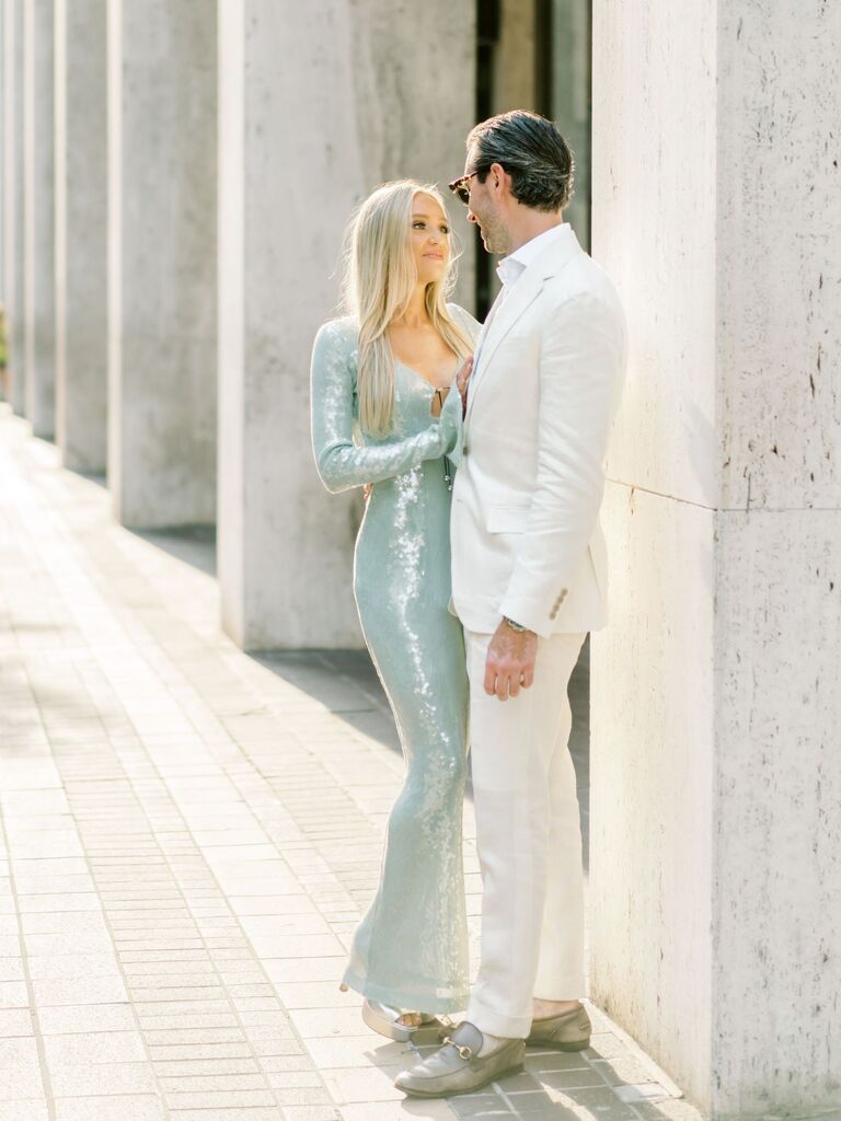 Couple in formal attire posing for summer engagement photos