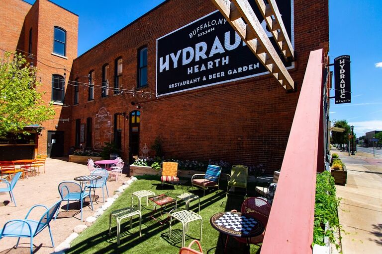 716 Swan St, Buffalo, NY 14210 - If you are planning to stay the weekend in Buffalo, lets keep the celebrations going!   We have reserved a space indoor/ outdoor for our guests to enjoy Saturday evening with us starting at 5:30PM. This venue is within a 10 min drive to both of our preferred hotels (9 minutes to The Westin and 7 minutes to The Hyatt Regency). Food and beverages will be available to purchase at Hydraulic Hearth the night of this event.