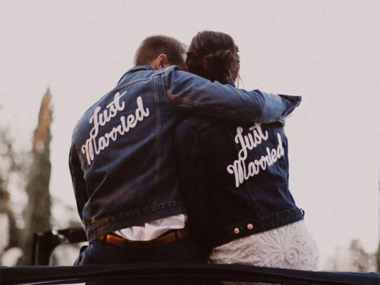 Matching denim jackets with 'Just married' in white script on back