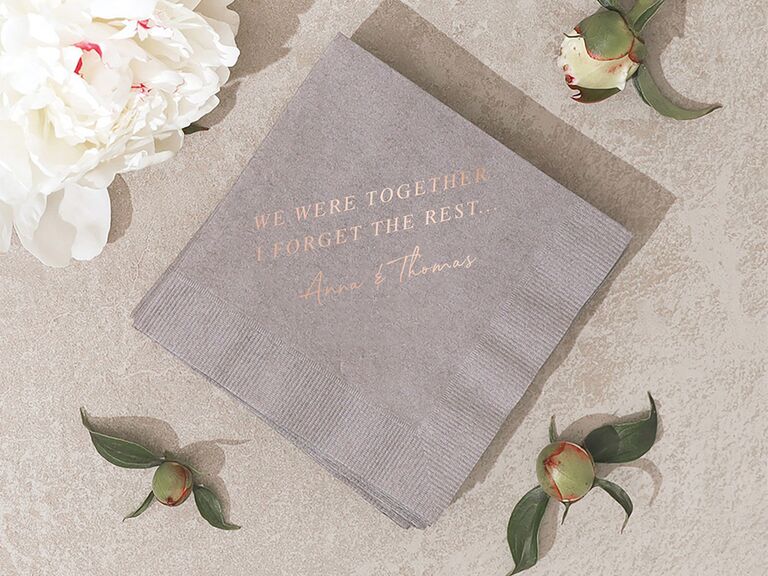 Gray napkin with 'We were together, I forgot the rest' and names in rose gold foil type
