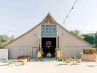 Outdoor barn wedding reception with string lights