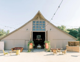 Outdoor barn wedding reception with string lights