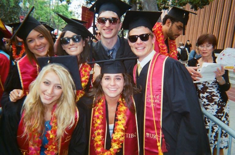 Edd and Molly sit next to each other at USC Graduation with Guest Speaker Jimmy Iovine and Dr. Dre. (Also pictured Bridesmaid Emily and Groomsman Aaron!)