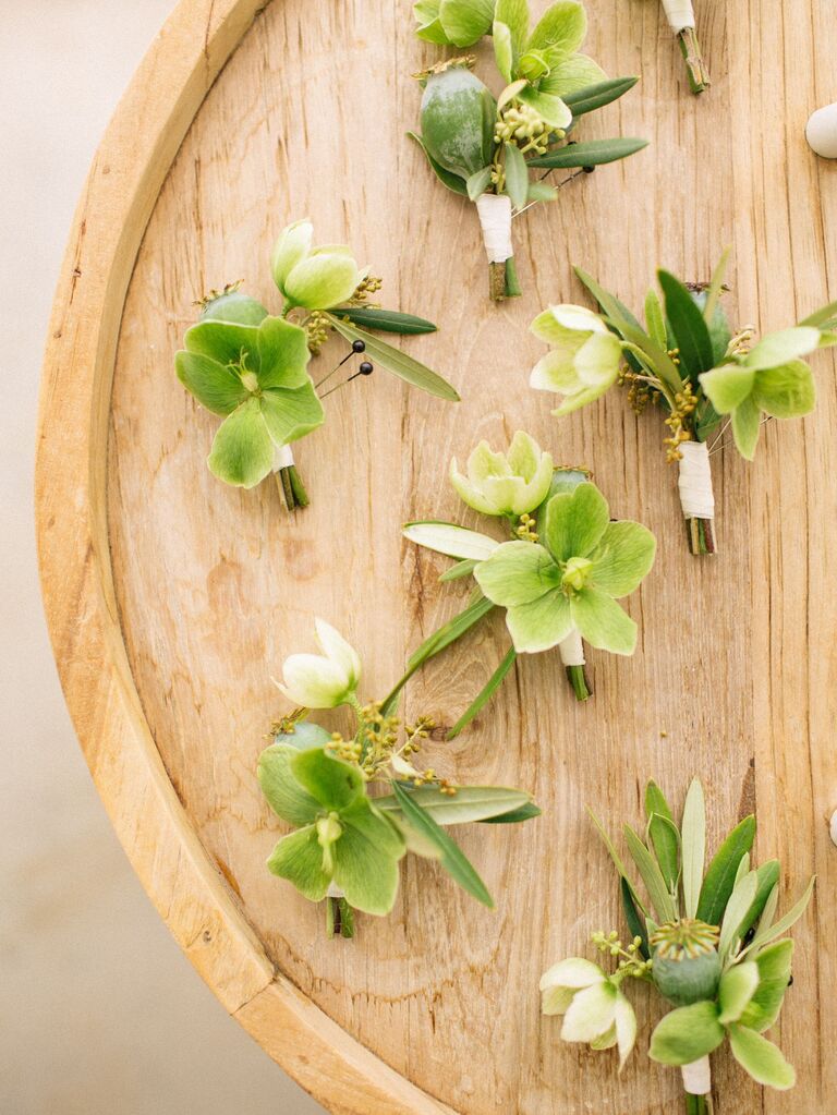 green hellebore wedding boutonnieres on a wooden tray