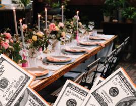 A couple lean in together, smiling, at this outdoor rehearsal dinner.