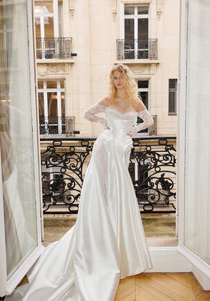A true highlight of the Lumierè collection, the dress features graceful voluminous 3D appliquès all over the skirt and creates that one of a kind gown silhouette, to make the bride feel like a princess. Elegant and neat top is a sleek corset with plunge neckline and distinct shape, decorated with minimalist lace appliques. The style is complemented with a striking veil echoing the gowns' 3D decoration at the bottom.