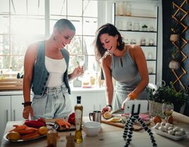 Young couple taking a cooking class at home paid for by wedding registry cash fund