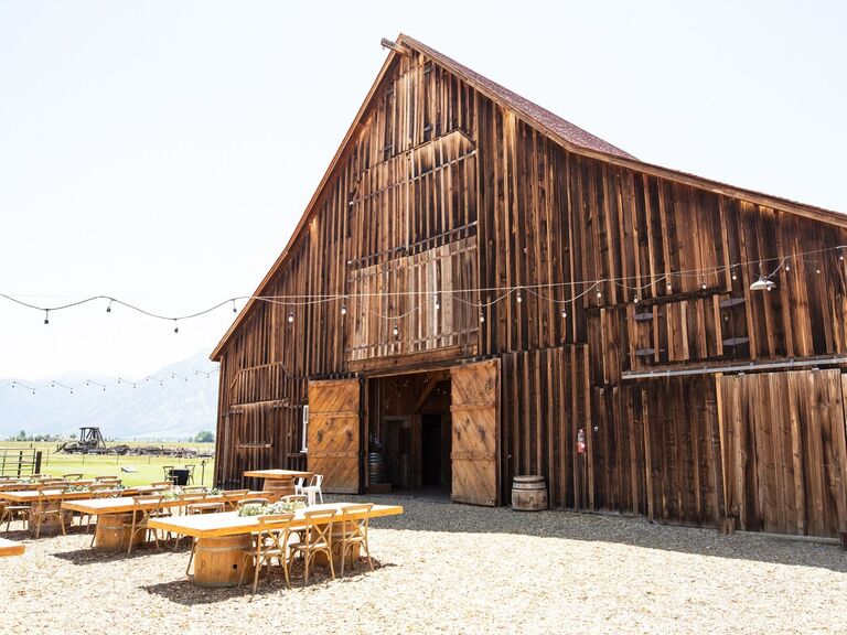 Outside view  of wooden barn venue with bistro lighting