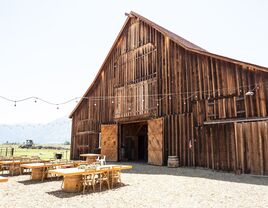 Outside view  of wooden barn venue with bistro lighting