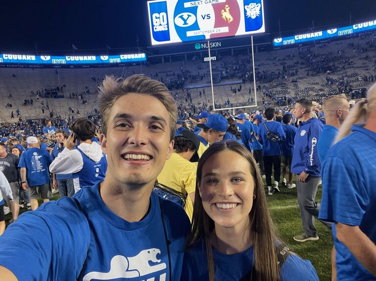 Brinley and Ethan met at the gym in September of 2022. They started chatting on the way in and got on the topic of BYU football. Brinley didn't have a ticket to the football game the next day. Ethan had an extra ticket and invited Brinley to go with him. This is a picture of them at that game!