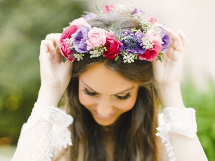 Bride wearing a purple and pink flower crown made of anemones and roses