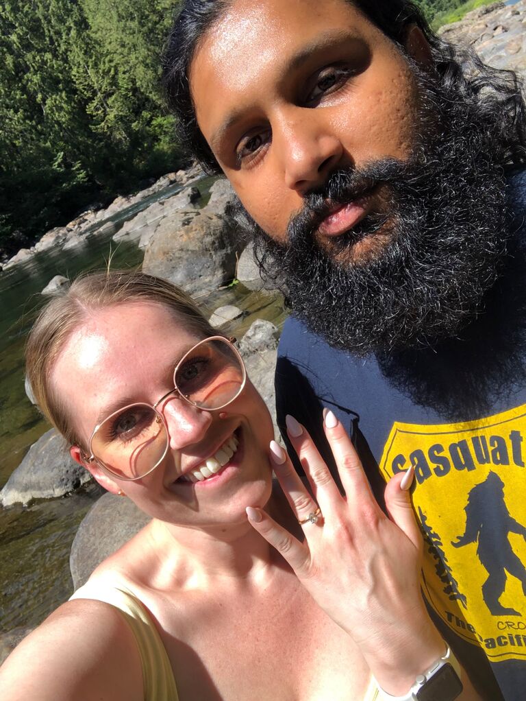 Engaged!!!! Kavel and I had planned to do a hike while in Seattle. He suggested a couple of places but we settled on Snoqualmie Falls. When we let that morning, I got into the truck to sit in the middle seat. He came out and asked me to sit next to the window....I thought this was strange but blew it off.  I got out, he slid in and off we went. We wanted to hike down right to the bottom of the falls but we couldn't figure it out. So we decided to walk along the river bank away from the falls. It was stupidly hot out and we were climbing over the biggest boulders I've ever seen. I was honestly dying a bit and I even asked Kavel if he wanted to turn back and he said nope and to keep going. We kept going when we saw this father teaching his son how to fish and in the distance we found a little beach in the rocks with a rose in the water. We both thought it was odd that a single rose would be growing in the water. So we did what anyone would do and walked over to check it out. We got to the little beach and I took my shoes off and walked through the water to the rose. I pulled on it gently and it came right out of the water. (As I was doing this, I figured Kavel was getting his shoes off to come join me in the water) when I turned around, Kavel was on one knee. I was so surprised. I even asked him if he was serious. I said a definite YES!!!!! 