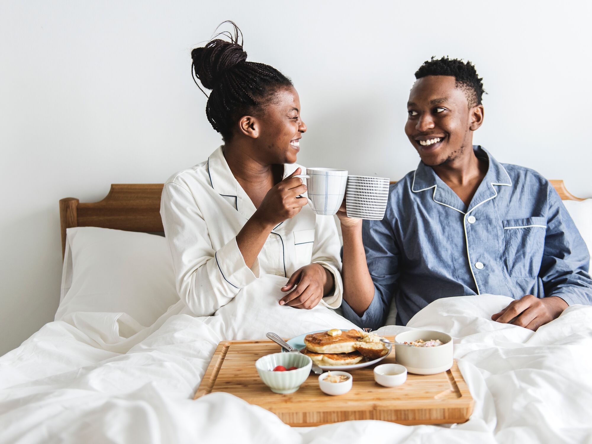 A couple having breakfast in bed at a b&b