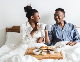 A couple having breakfast in bed at a b&b