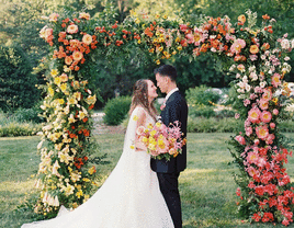 Couple under a floral arch