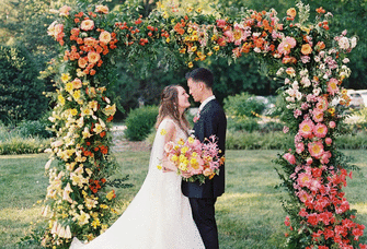 Couple under a floral arch