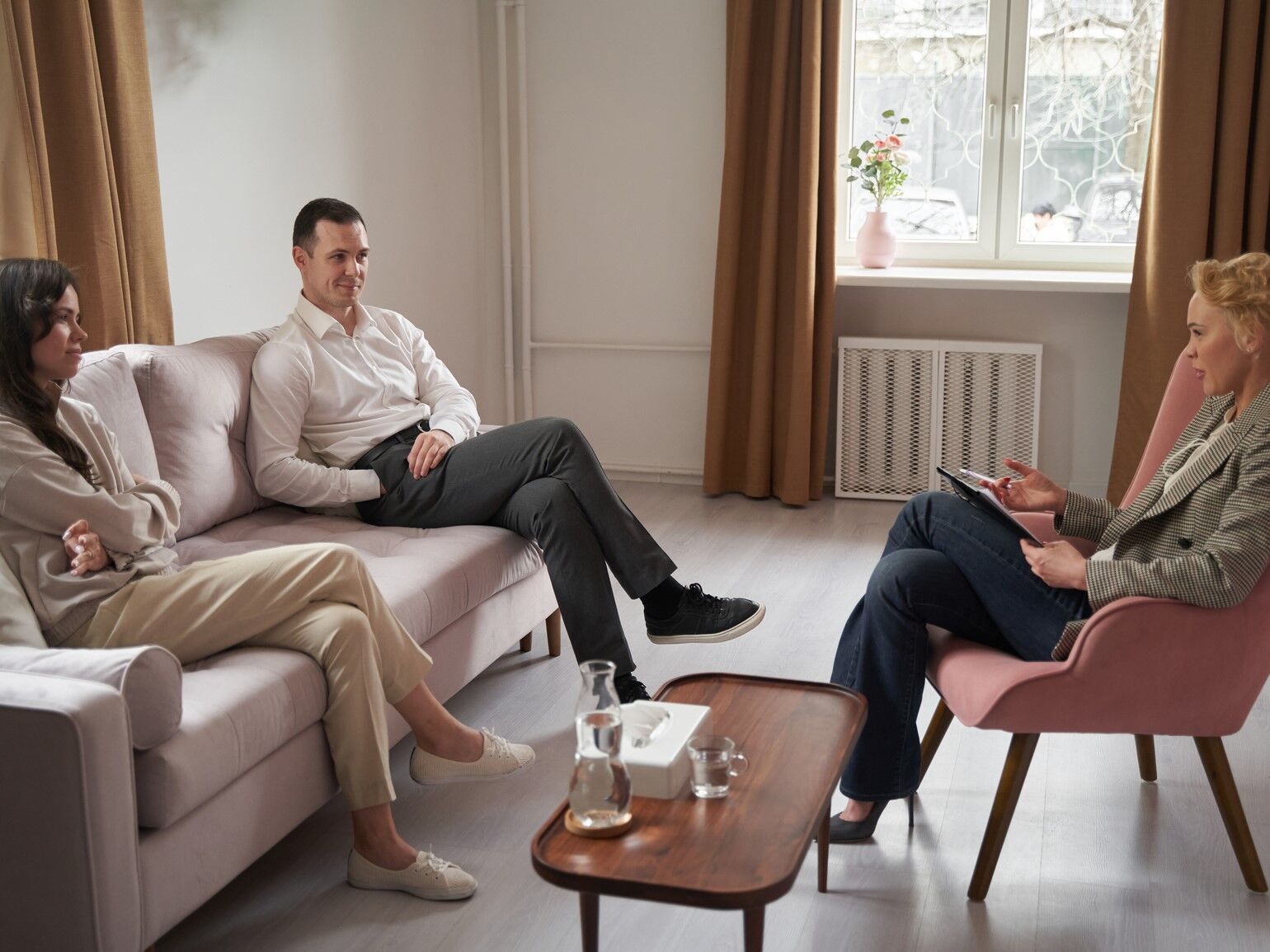 Couple sitting with their premarital counsellor