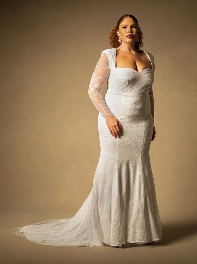 Model wearing a long-sleeved mermaid style wedding dress. 