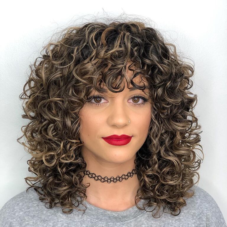 Bouncy curls wedding guest hairstyle
