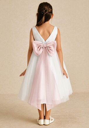 Kavi is our adorable flower girl dress cut from satin and tulle. She features a scoop neckline paired, the look is complete with an A-line skirt. This dress is not only perfect for a flower girl at a wedding but also versatile enough for other special occasions.