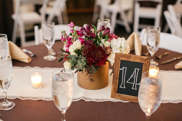 Jewel Toned Flower Arrangements In Gold Vases